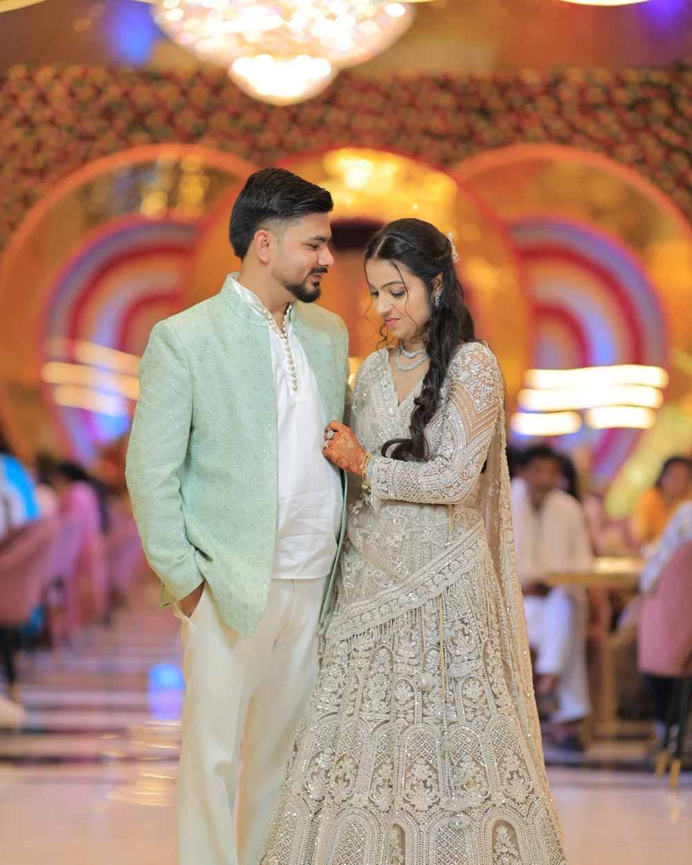 Couple walking in together through a colourful reception hall