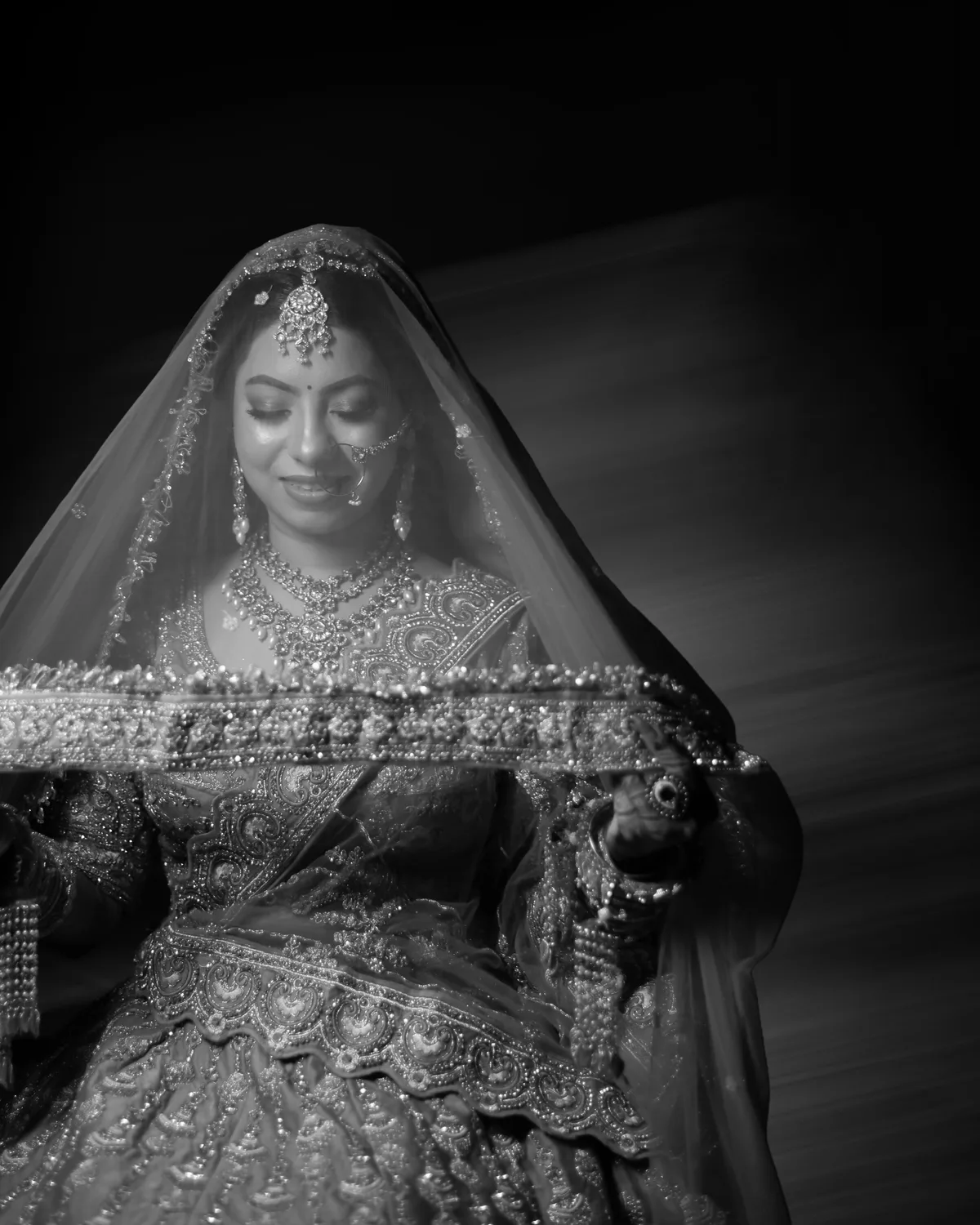 Black-and-white portrait of a bride under a sheer veil