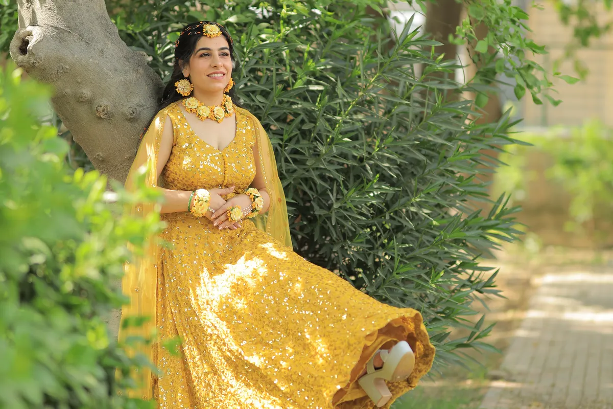 Bride in a yellow lehenga in a garden